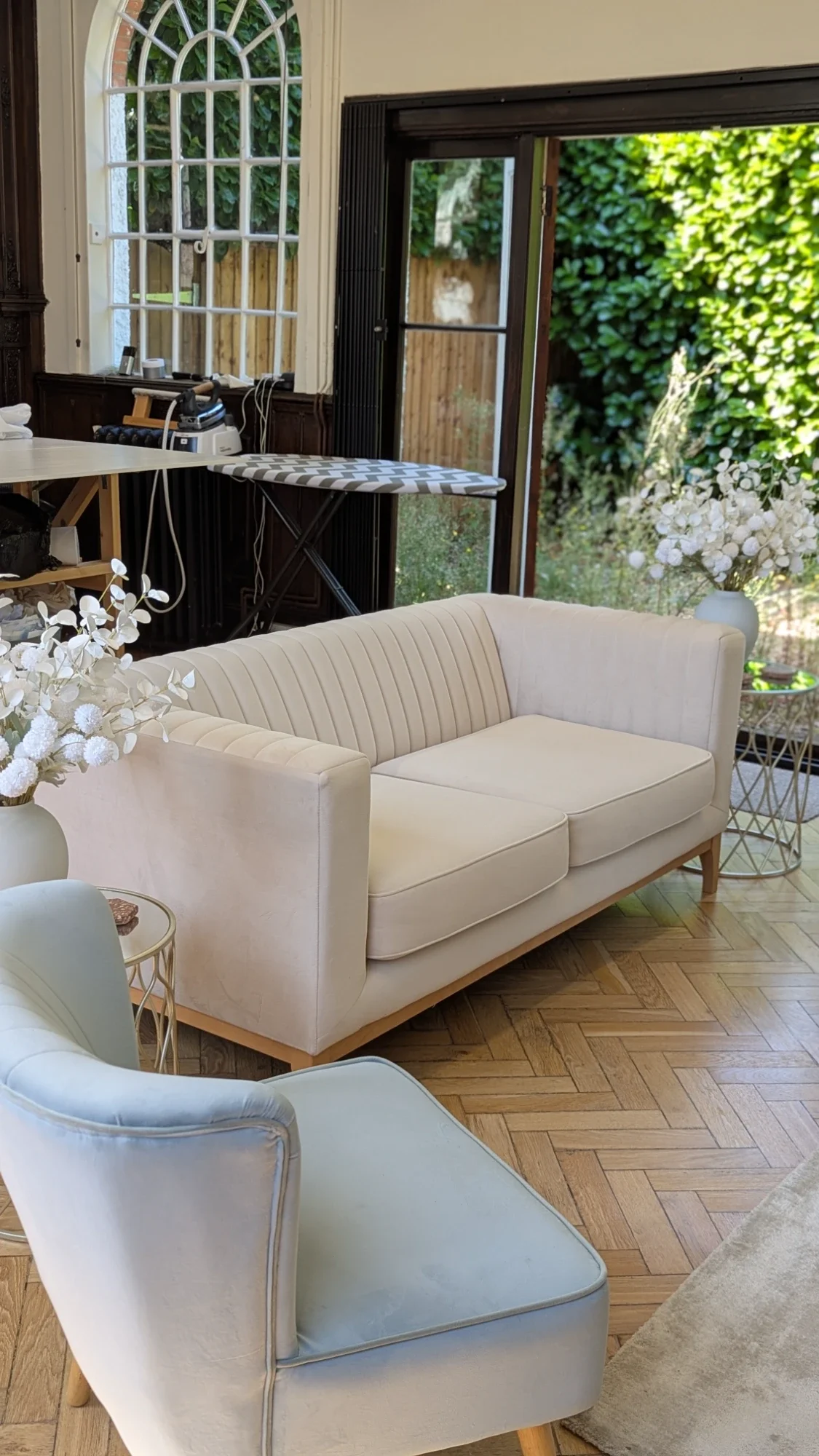 Bridal studio fitting lounge with velvet seating and garden doors open to the courtyard