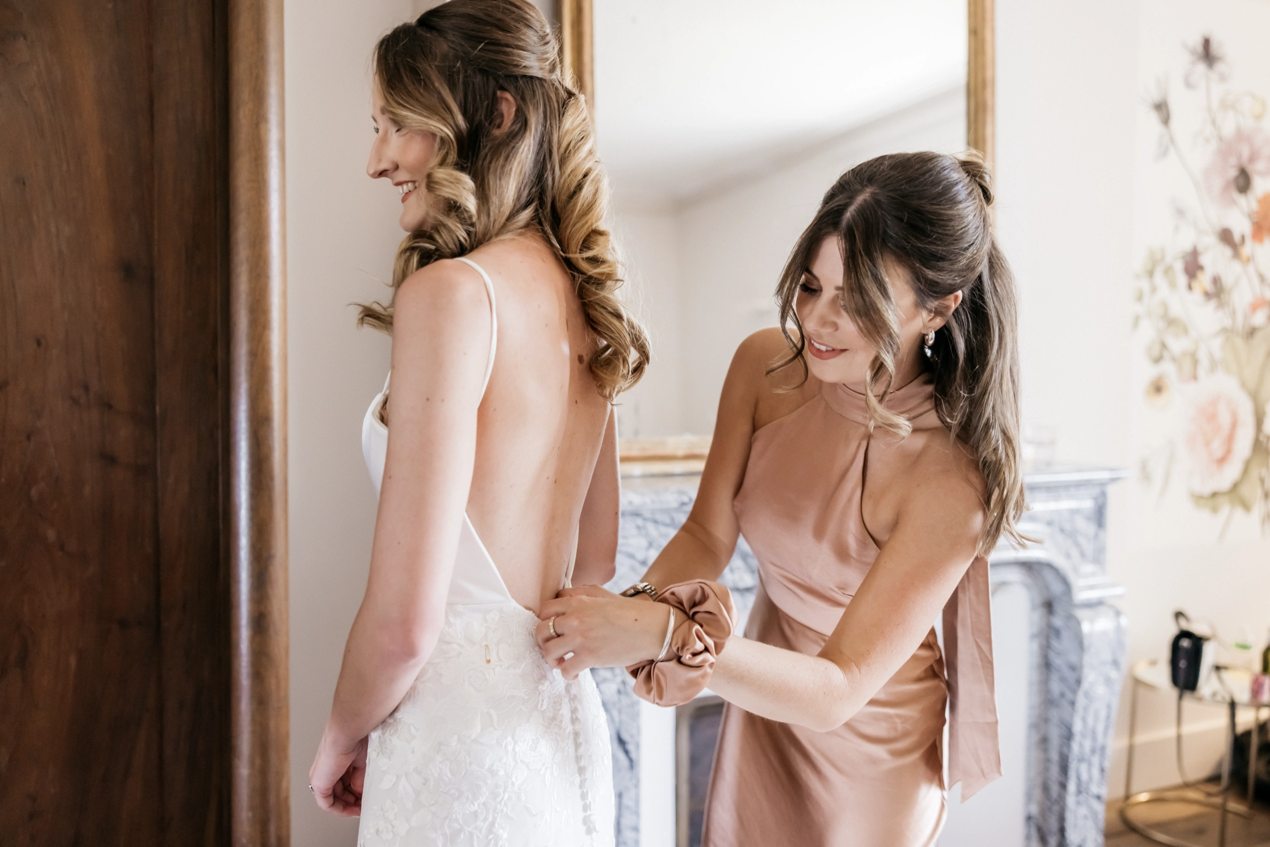Custom Italian silk wedding gown, back view as the bride is fastened into her lace bodice