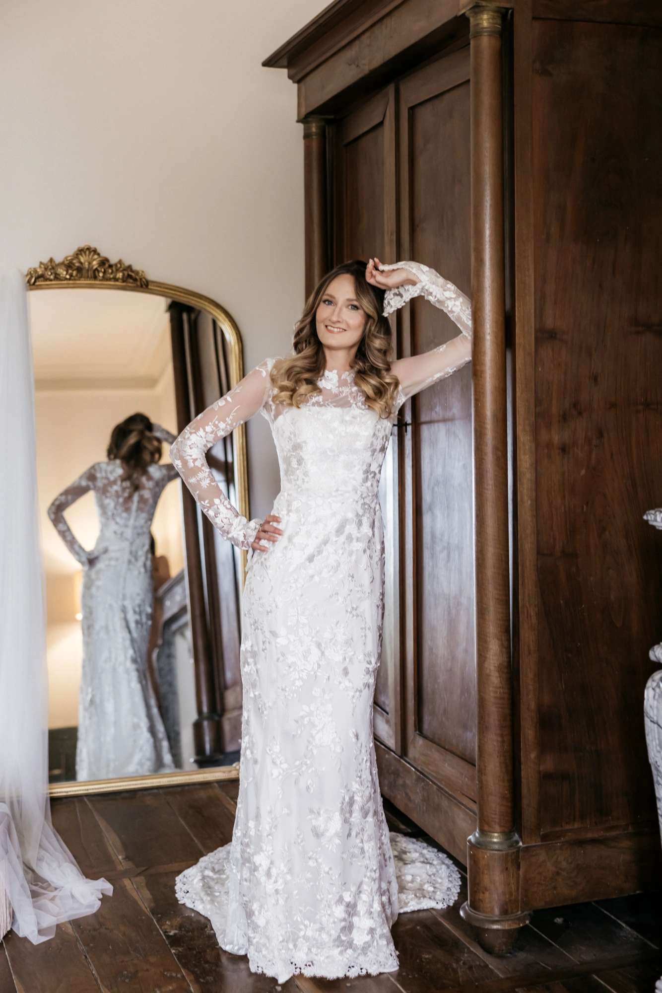 Custom Italian silk wedding gown with all-over lace, front view in the chateau dressing room