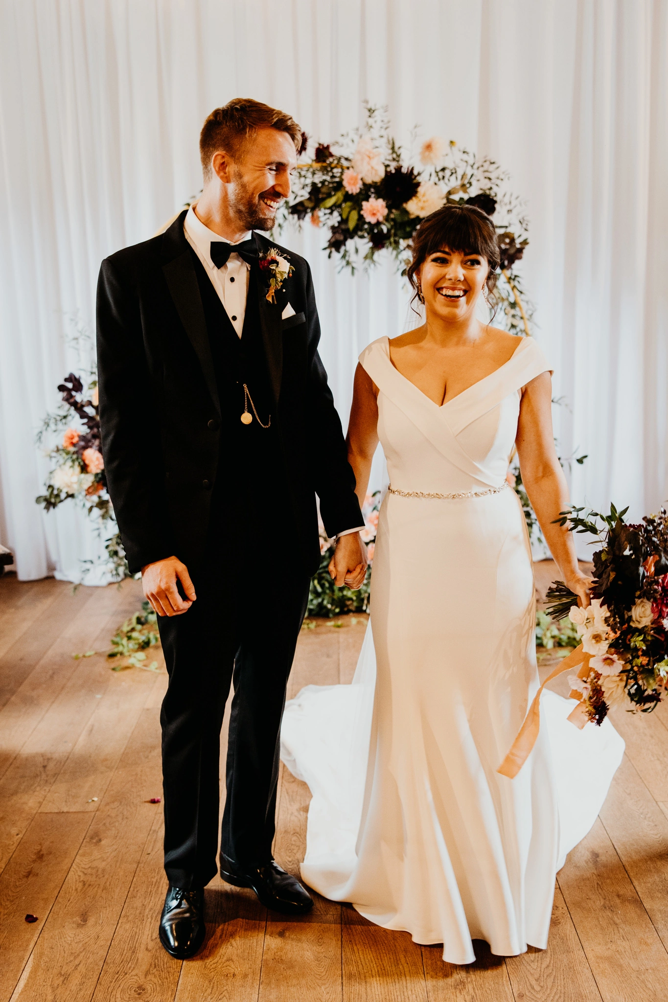 Custom ivory crepe fit-and-flare wedding dress with a sparkly belt, front view